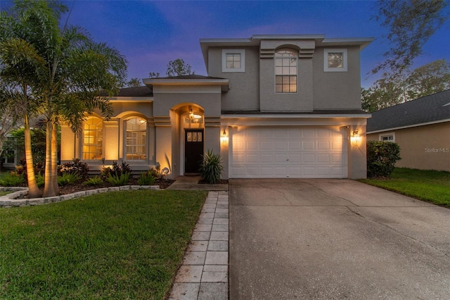 view of front of house with a lawn and a garage