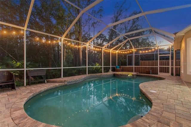 view of swimming pool featuring a patio area and a lanai