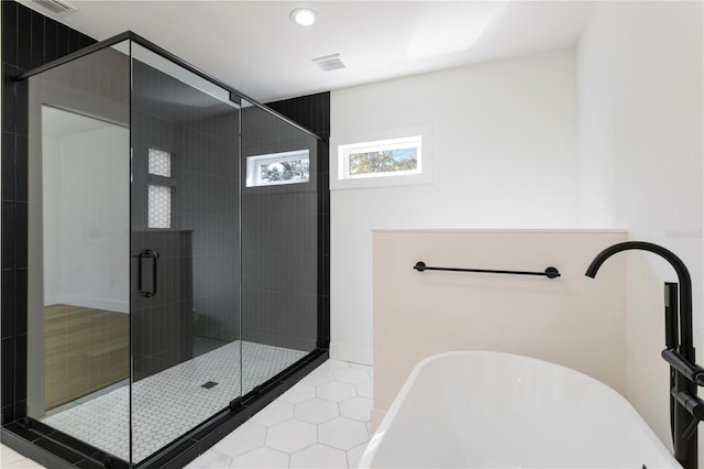 bathroom with independent shower and bath, tile patterned floors, and sink