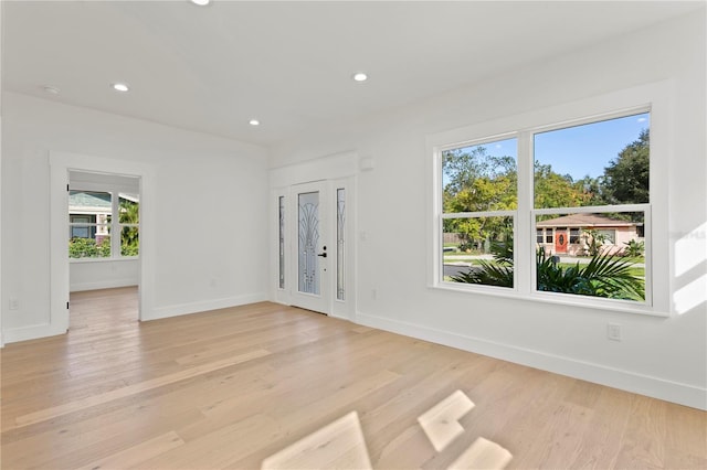 unfurnished room with light wood-type flooring