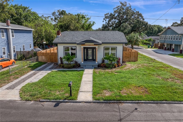 bungalow-style home with a front lawn