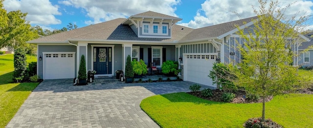 view of front facade with a front yard, covered porch, and a garage