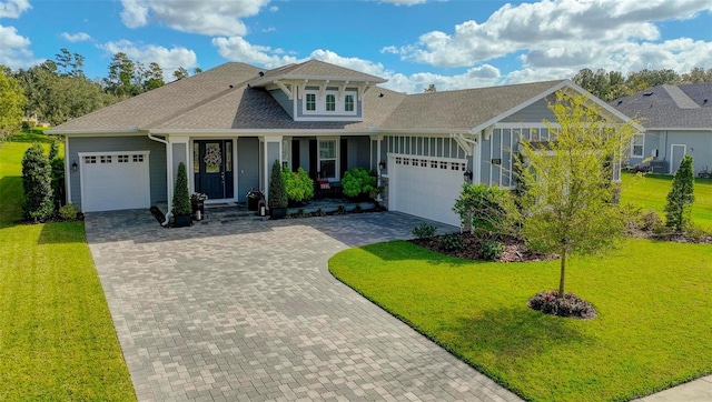 view of front of home with a garage and a front lawn