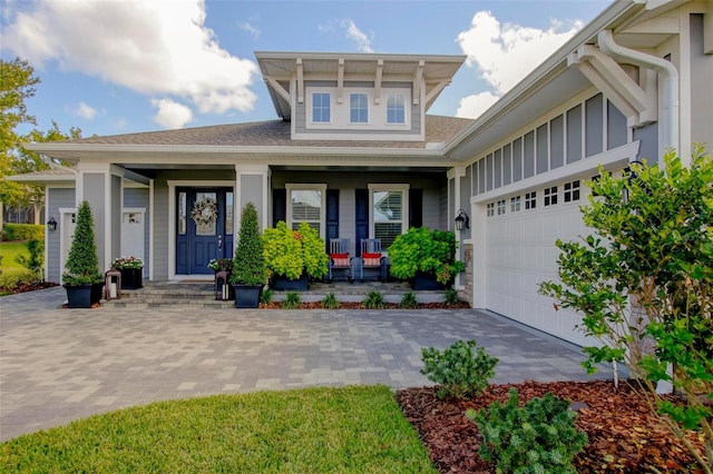 view of front facade featuring a garage and covered porch