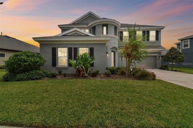 view of front of house featuring a garage and a yard