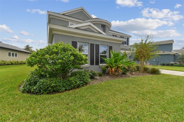 6317 Brevada Ln, Apollo Beach, FL 33572 - view of front facade with stucco siding and a front lawn