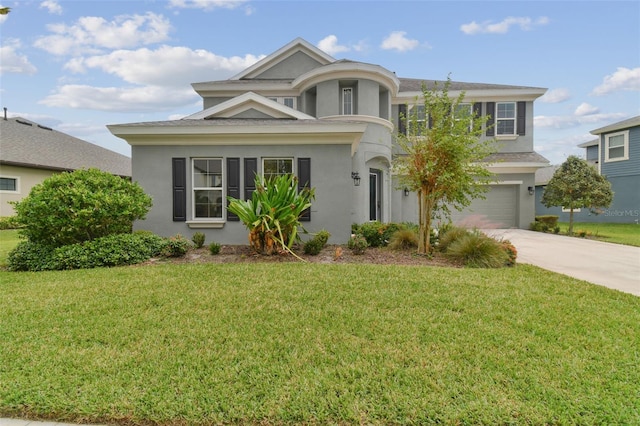 view of front facade featuring a garage and a front lawn