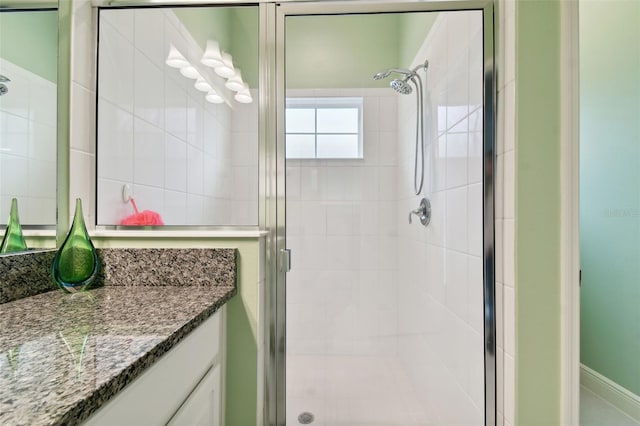 bathroom with vanity and a shower with shower door