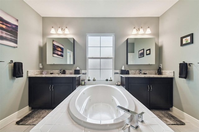 bathroom featuring vanity, a relaxing tiled tub, and tile patterned flooring