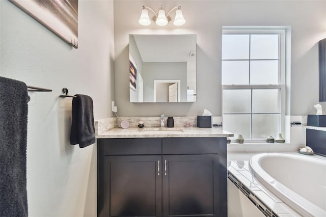 bathroom with a relaxing tiled tub and vanity