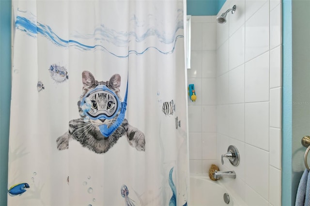 bathroom with shower / bath combo with shower curtain