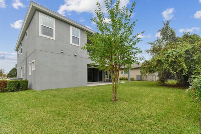 back of property featuring a lawn