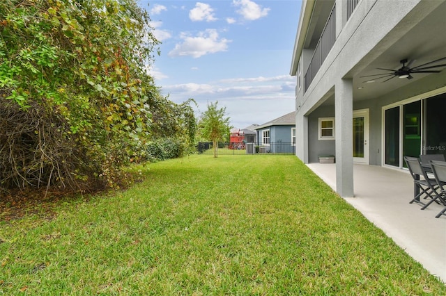 view of yard with a patio and ceiling fan