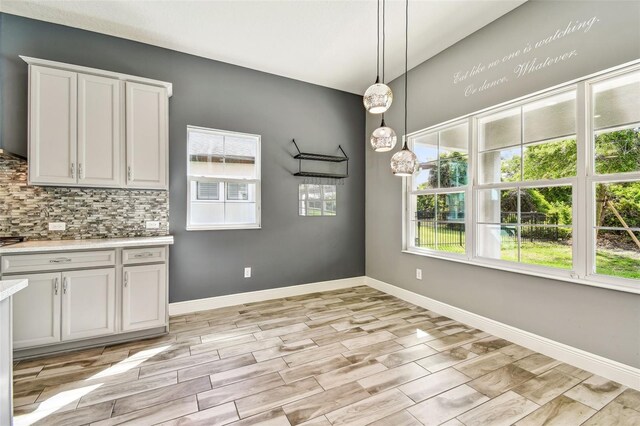 6317 Brevada Ln, Apollo Beach, FL 33572 - unfurnished dining area featuring light wood-style floors and baseboards