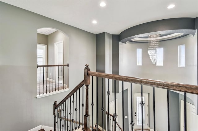6317 Brevada Ln, Apollo Beach, FL 33572 - hallway with arched walkways, recessed lighting, and a chandelier
