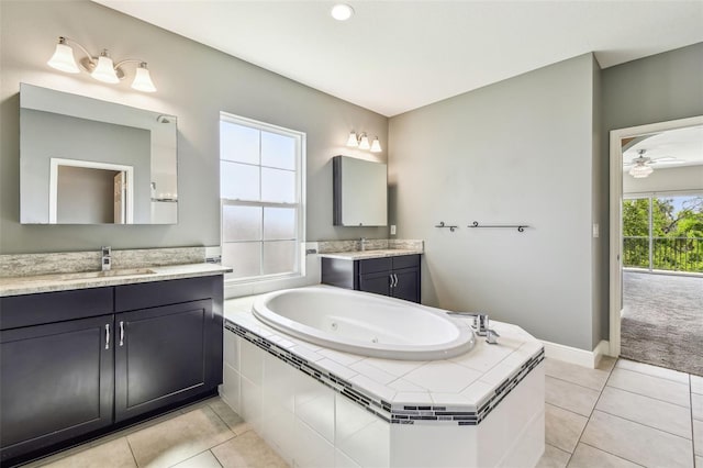 6317 Brevada Ln, Apollo Beach, FL 33572 - bathroom with tile patterned flooring, a tub with jets, two vanities, and ceiling fan