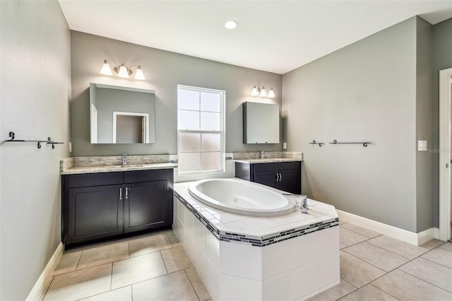 6317 Brevada Ln, Apollo Beach, FL 33572 - bathroom featuring a garden tub, two vanities, baseboards, and tile patterned flooring