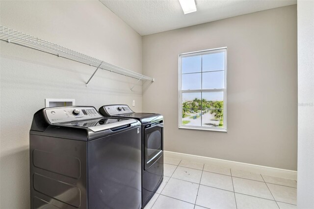 6317 Brevada Ln, Apollo Beach, FL 33572 - laundry area with washing machine and clothes dryer, baseboards, and light tile patterned floors