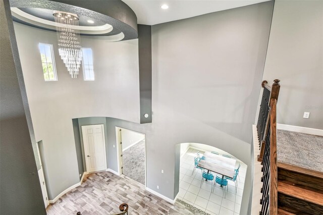 6317 Brevada Ln, Apollo Beach, FL 33572 - staircase with a chandelier, recessed lighting, a towering ceiling, and baseboards