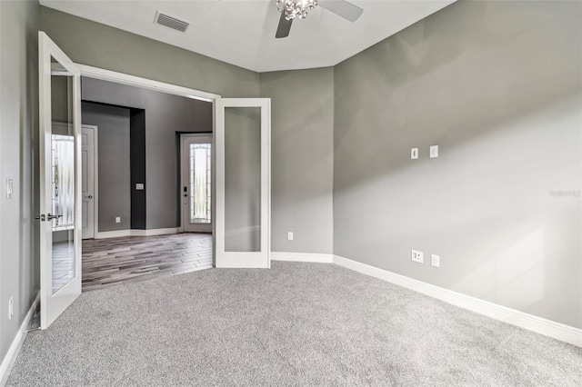 6317 Brevada Ln, Apollo Beach, FL 33572 - empty room with french doors, carpet flooring, a ceiling fan, and baseboards