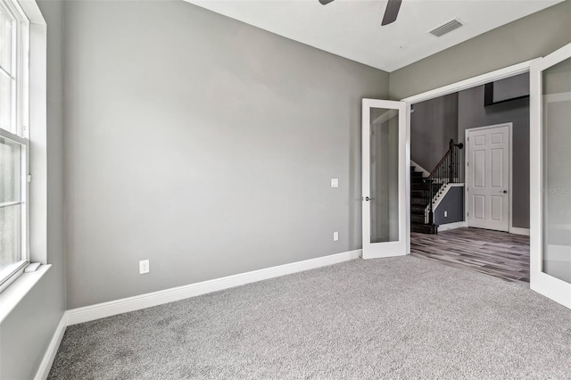 6317 Brevada Ln, Apollo Beach, FL 33572 - unfurnished bedroom with carpet floors, french doors, baseboards, and a ceiling fan