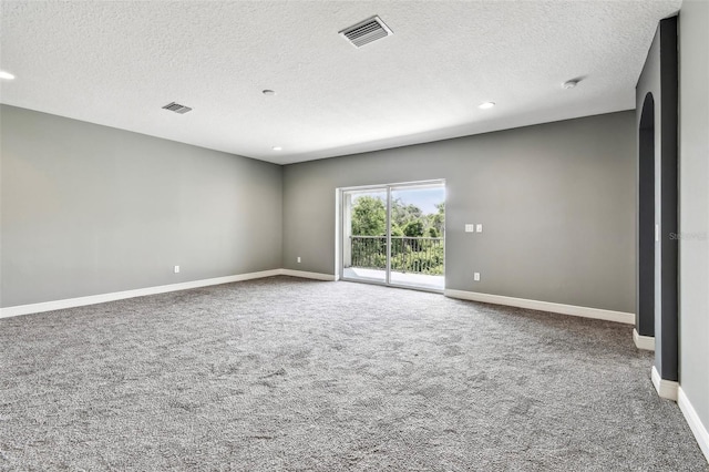 6317 Brevada Ln, Apollo Beach, FL 33572 - carpeted empty room featuring a textured ceiling, recessed lighting, baseboards, arched walkways, and a smoke detector