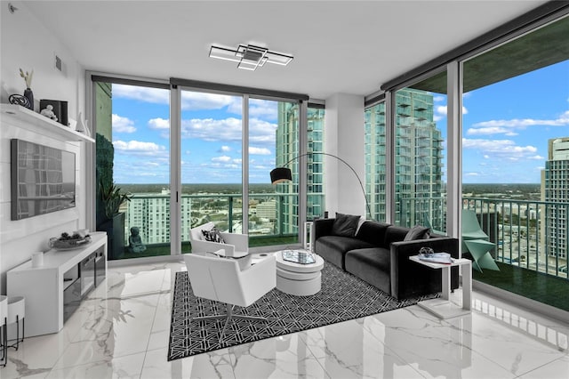 living area featuring marble finish floor, visible vents, a wall of windows, and a city view