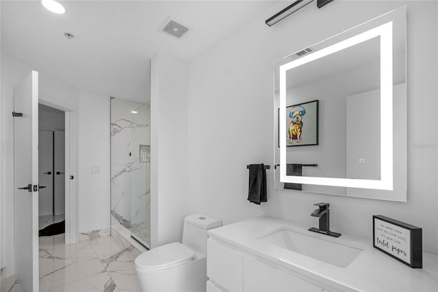 bathroom featuring vanity, toilet, and a tile shower