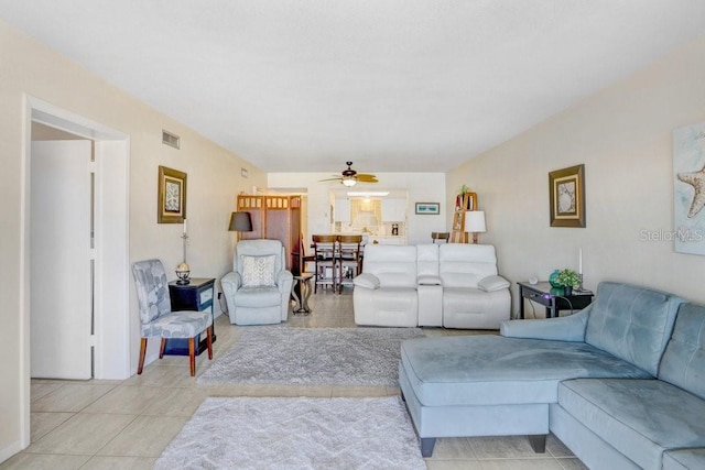 living room featuring ceiling fan and light tile patterned floors