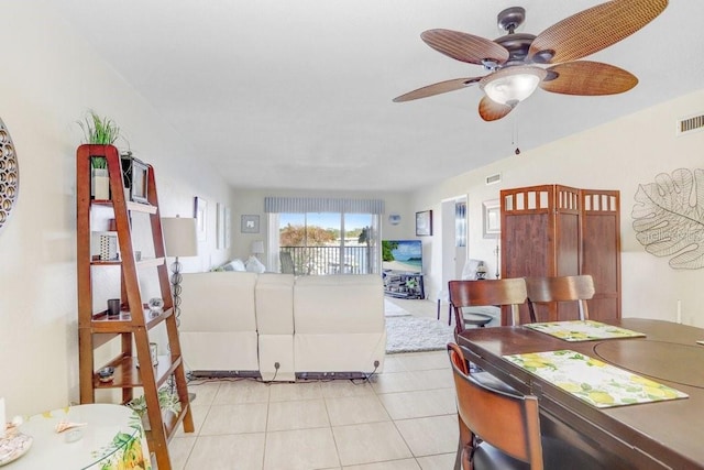 tiled living room featuring ceiling fan