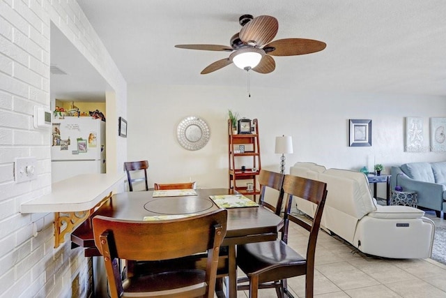 dining space with ceiling fan and light tile patterned floors