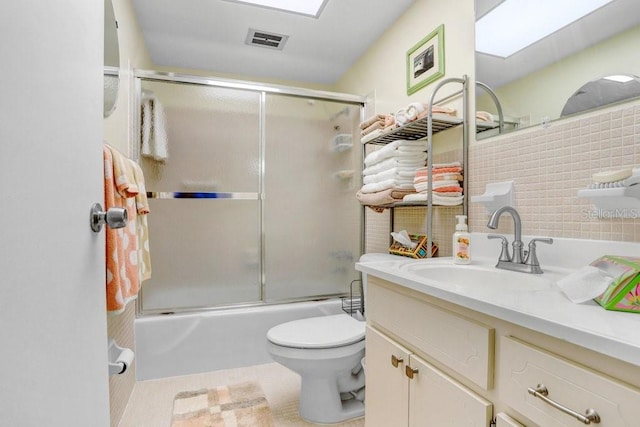 full bathroom with vanity, toilet, tile patterned floors, and combined bath / shower with glass door