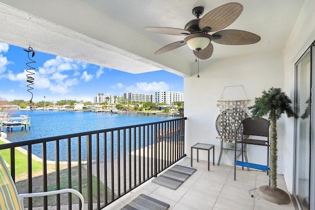 balcony featuring a water view and ceiling fan