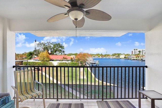 balcony with a water view and ceiling fan