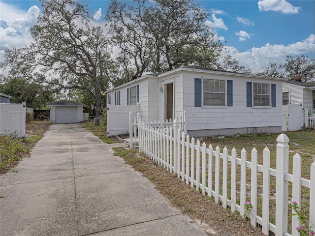 view of front of property with a garage and an outdoor structure