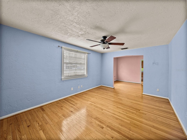 unfurnished room featuring ceiling fan, a textured ceiling, and light hardwood / wood-style floors