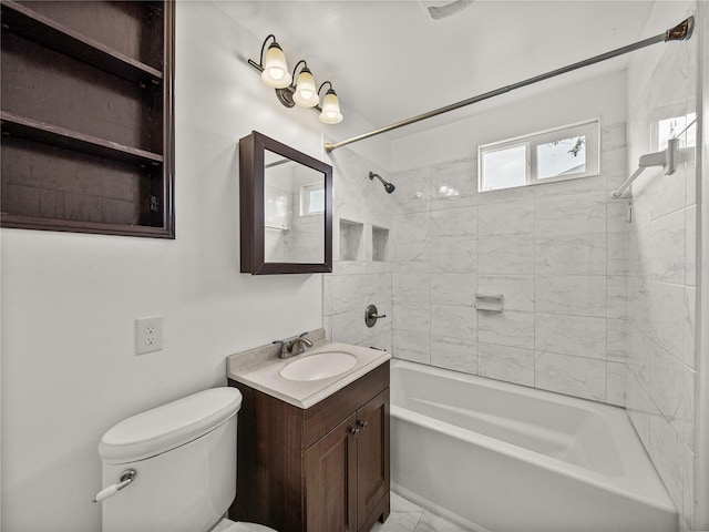 full bathroom with toilet, vanity, and tiled shower / bath