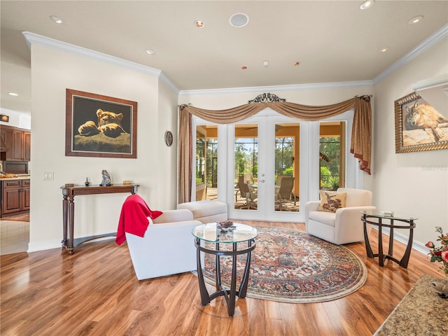 living room featuring french doors, hardwood / wood-style flooring, and crown molding