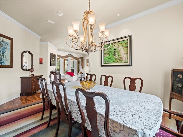 dining area featuring an inviting chandelier, hardwood / wood-style flooring, and ornamental molding