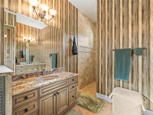 bathroom with vanity and tiled shower