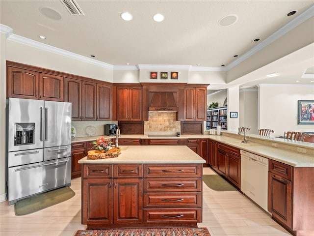 kitchen featuring white dishwasher, stainless steel refrigerator with ice dispenser, kitchen peninsula, custom range hood, and crown molding