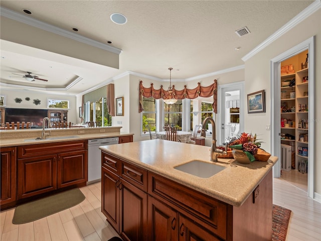 kitchen with white dishwasher, a textured ceiling, sink, an island with sink, and pendant lighting