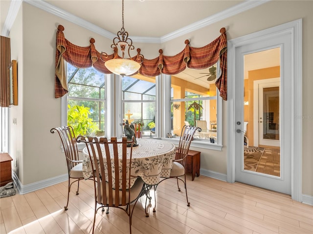 dining space featuring a notable chandelier, crown molding, and light hardwood / wood-style flooring