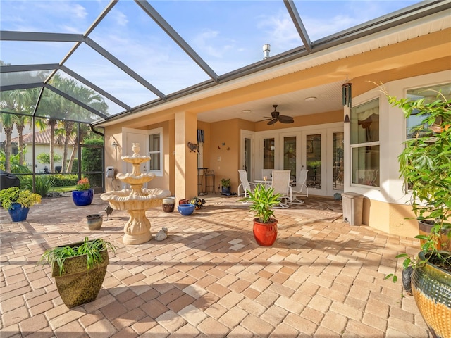 view of patio / terrace featuring a lanai, french doors, and ceiling fan