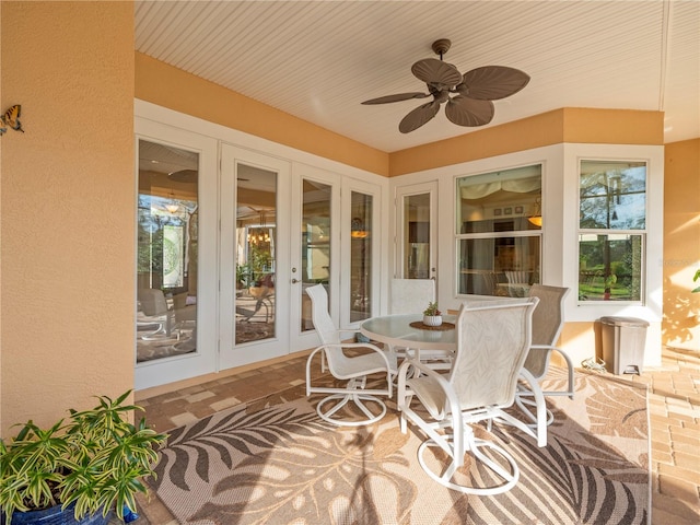 sunroom / solarium with french doors and ceiling fan