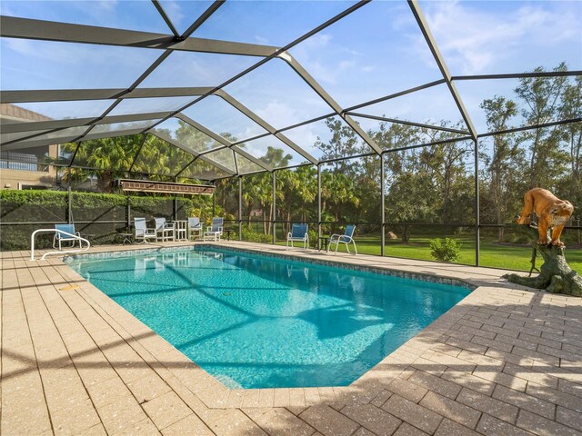 view of pool with a lanai and a patio area