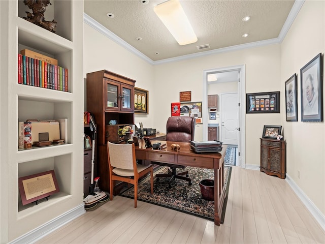 office space featuring ornamental molding, light hardwood / wood-style floors, a textured ceiling, and built in features