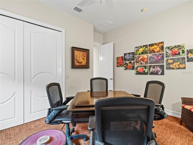 carpeted home office featuring ceiling fan