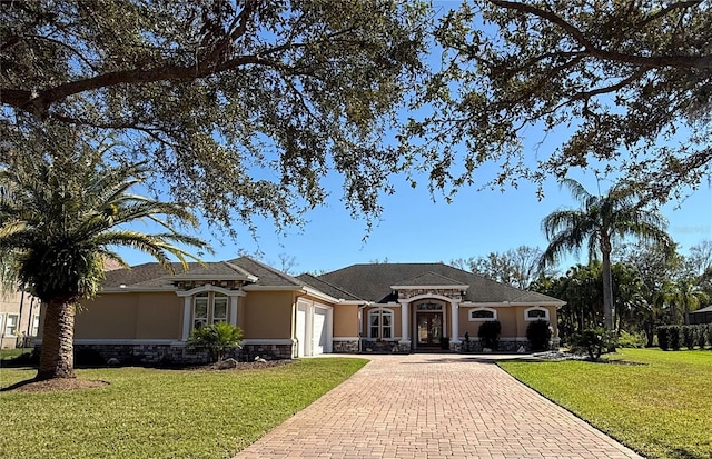 ranch-style house featuring a front lawn and a garage