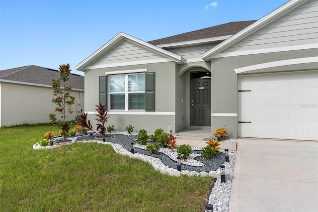 ranch-style home with a front lawn and a garage